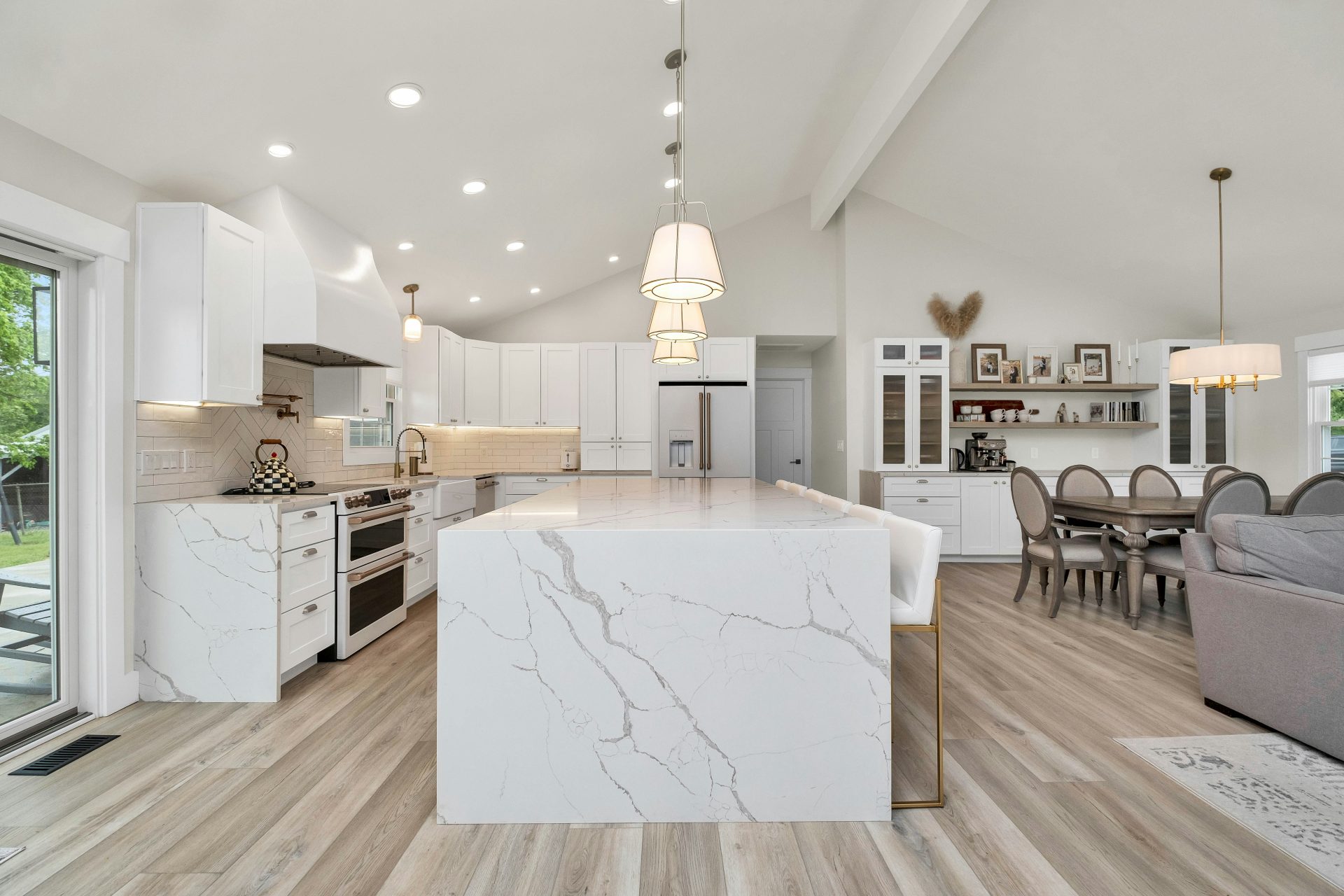 a large kitchen with a center island in the middle of the room